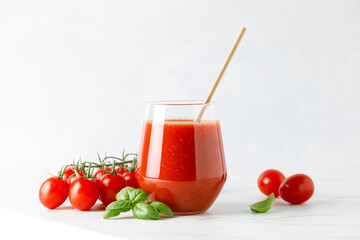 Tomato juice in a glass and fresh tomatoes