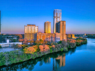 Fototapeta premium Austin, Texas- Colorado River with a reflection of the buildings with sunset glow