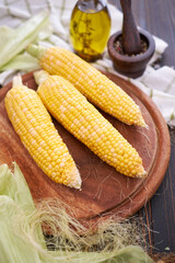 Organic natural corn cobs on wooden kitchen table