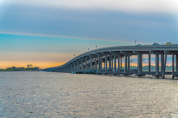 Destin Bridge over the sea against the sunset sky at Destin, Florida