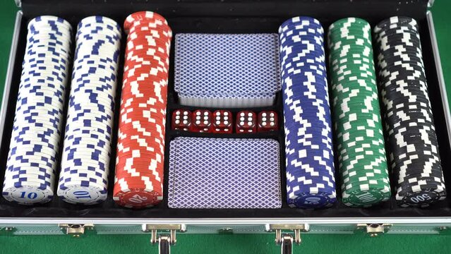 Start playing poker. Opening silver suitcase with set for poker game.