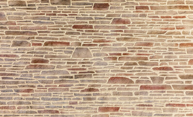 Vieux mur de pierre sur une façade en France.