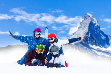 family and snowboard on snowy mountain