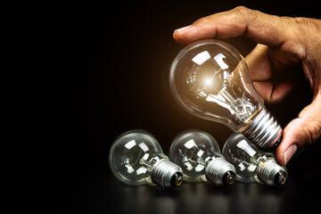 Close up hand choose light bulb or lamp with bright light for human resources or leadership and creativity thinking idea motivation or vision and knowledge learning and study or education concept.