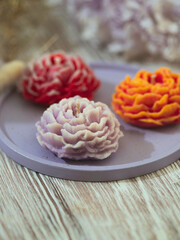 Handmade candles in modern style, beautiful shape. Flower candle. Home decor.