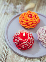 Handmade candles in modern style, beautiful shape. Flower candle. Home decor.