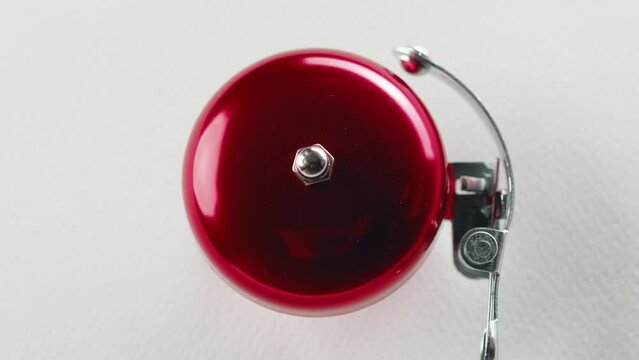 Red fire alarm bell on the white wall of a palace 