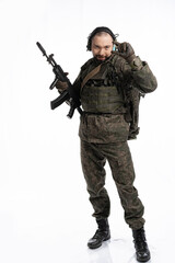 soldier in the studio on a white background. a man in military uniform with a rifle or machine gun. military or airball player