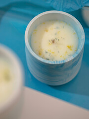 Soy candle in a concrete, plaster candlestick, decor interior. Home decoration with a burning scented candle. Spa. Natural.