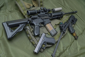 Firearms and tactical equipment.  A pistol, a conversion kit with a pistol and an ar 15 type rifle.