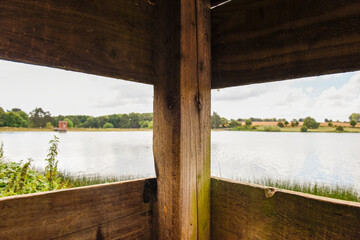 View from inside a bird hide for birdwatching with view out over water