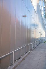 Footpath with handrails near the metal wall of a building at Phoenix, Arizona