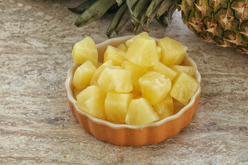Marinated pineapple slices in the bowl