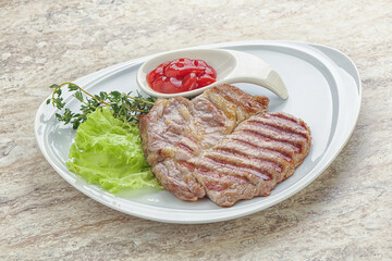 Grilled pork neck steak with ketchup