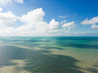 Landscape of blue turquoise water and blue sky with clouds, serene and peaceful atmosphere concept