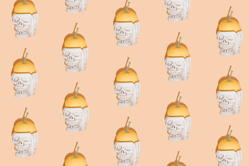 Creative Halloween background with skulls and pumpkins. Seamless pattern.