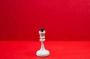 chess queen and pawns on red background