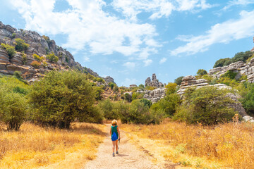 Fototapeta na wymiar A young woman trekking in the Torcal de Antequera on the green and yellow trail, Malaga. Spain