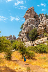 A young woman trekking enjoying the Torcal de Antequera on the green and yellow trail, Malaga