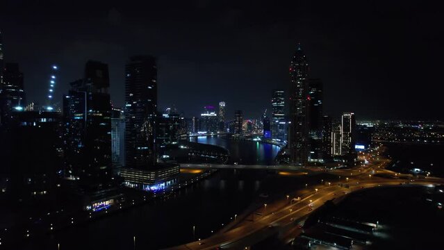 Flying a drone over a night Dubai. Aerial view