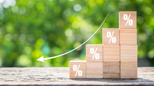 Cost reduction business finance concept, Wooden cube block with down arrows, Depreciation of national currency, inflation, investment attractiveness. Economic decline fall difficulties.