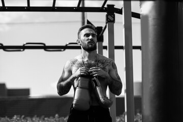 Part of man wearing boxing gloves.