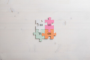 Word Solution spelled with syllables on four matching colorful puzzle pieces