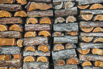 Woodpile. Textured firewood background. Pile of old dry chopped fire wood