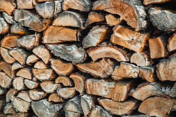 Woodpile. Textured firewood background. Pile of old dry chopped fire wood