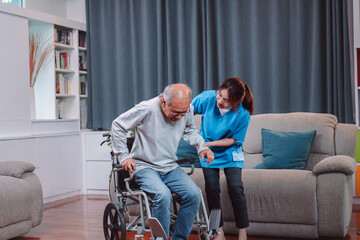 Fototapeta na wymiar Asian senior elderly man patient doing physical therapy with caregiver. woman nurse helping get up from wheelchair for practice walking at home, practice walking slowly at nursing home care concept.