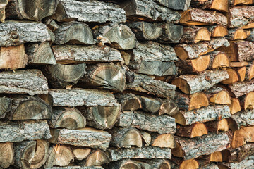 Woodpile. Textured firewood background. Pile of old dry chopped fire wood
