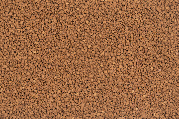 Granulated brown coffee background texture close up. instant coffee