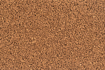 Granulated brown coffee background texture close up. instant coffee