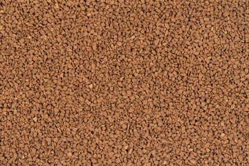 Granulated brown coffee background texture close up. instant coffee