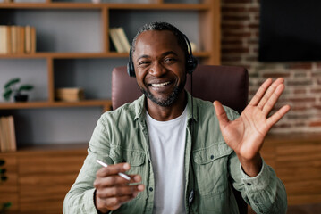 Customer support and work at home. Smiling adult african american guy manager in casual and...