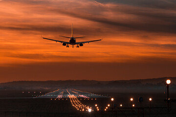 Fototapeta na wymiar The plane lands at the airport in Balice, Kraków. Samolot ląduje na lotnisku w Balicach, Kraków.