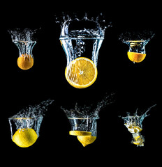 Set of lemons and oranges with water splash isolated on black background. Collection of lemons and oranges falling into the water. Big size.