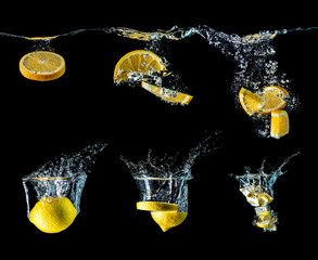 Set of lemons and oranges with water splash isolated on black background. Collection of lemons and oranges falling into the water. Big size.