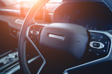Steering wheel in luxury car with black salon.