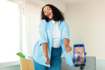 Black Female Blogger Making Video On Smartphone Dancing At Home