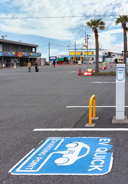 chiba, japan - july 18 2022: EV quick charging point sticker on asphalt for electric cars on the parking area of the Tokyo bay ferry terminal at Kanaya port on the Uraga Channel in the Bōsō Peninsula.
