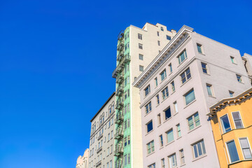 Row of tall residential buildings in a low angle view at San Francisco, CA