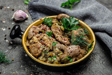 Stewed chicken stomach, Traditional Korean spicy chicken gizzard with onions, garlic, chili and sesame on a dark background, place for text, top view