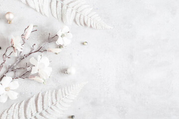 Winter composition. White flowers on gray background. Christmas, winter concept. Flat lay, top view