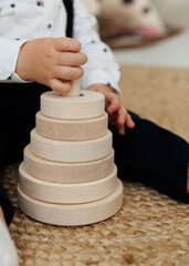 Children's hand with a wooden toy close-up