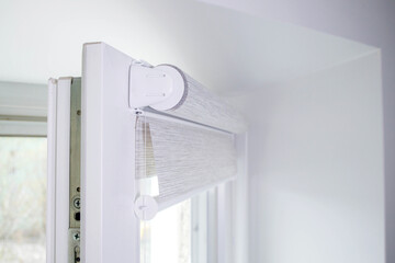 Close up mechanism of tnaninny roller blinds indoors. Duo window roller system day and night.