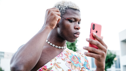 Non binary model applying makeup on street