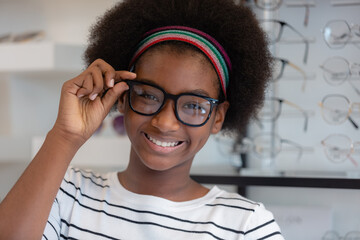 close up, happy young woman African american afro hair smile wear spectacles and holding glasses...