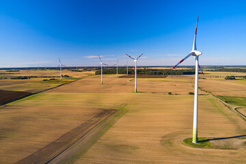 A line of wind turbines in Europe. Landscape with wind generators. The issue of energy saving in the modern world