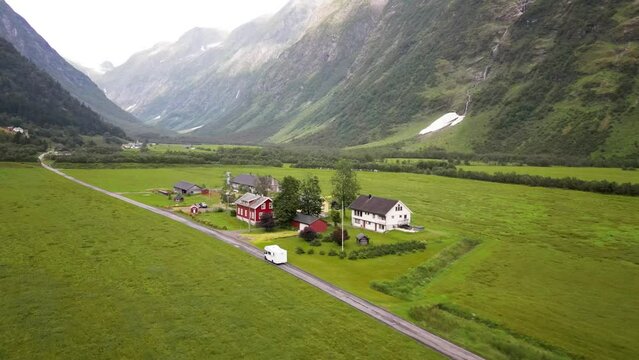 Aerial, drone following RV, family holiday trip in motorhome, Caravan car Vacation. Beautiful Nature Norway, natural landscape.